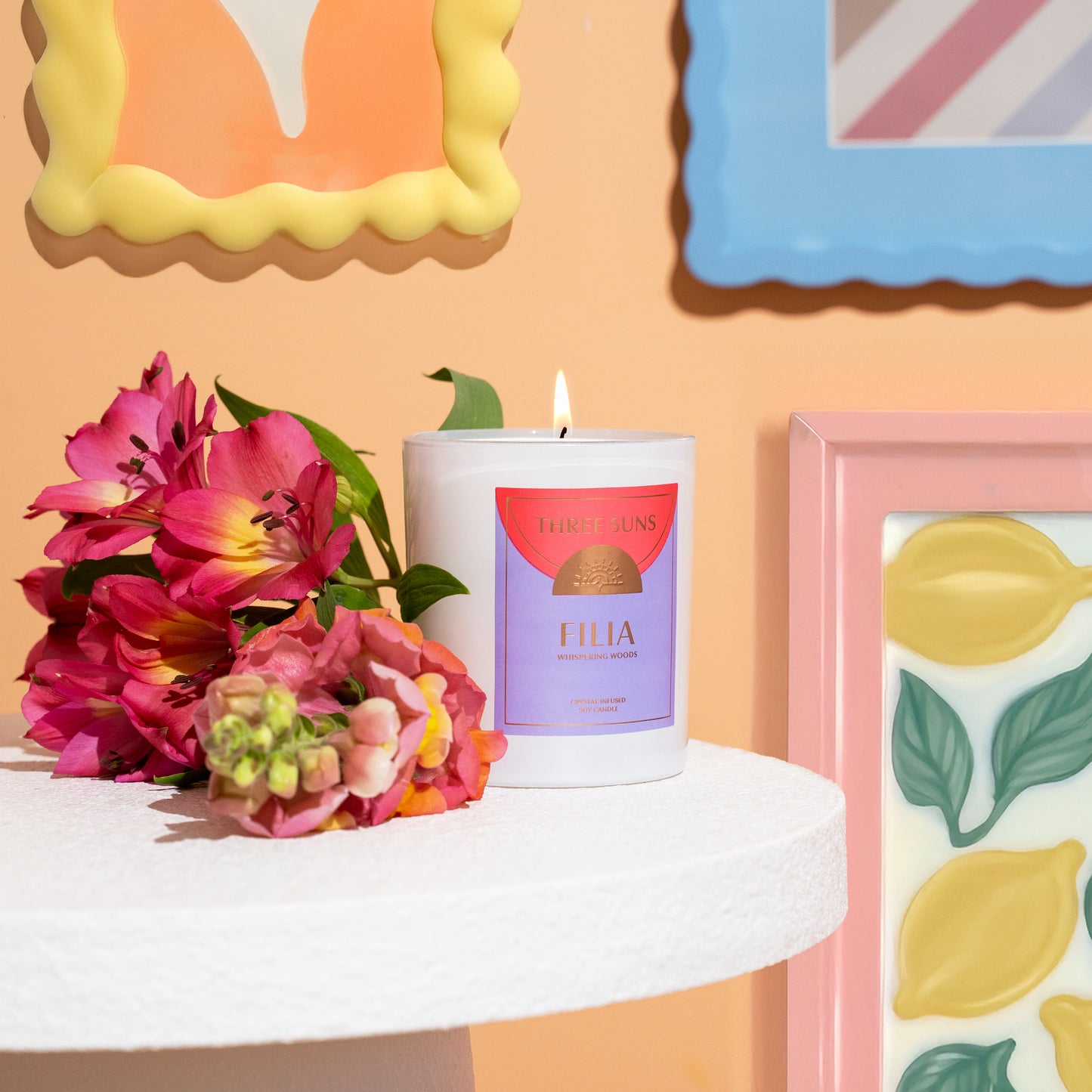 Large Filia Crystal Soy Candle, natural soy wax candle, featured in a luxury colourful Australian home next to flowers by Three Suns gold foil on label.